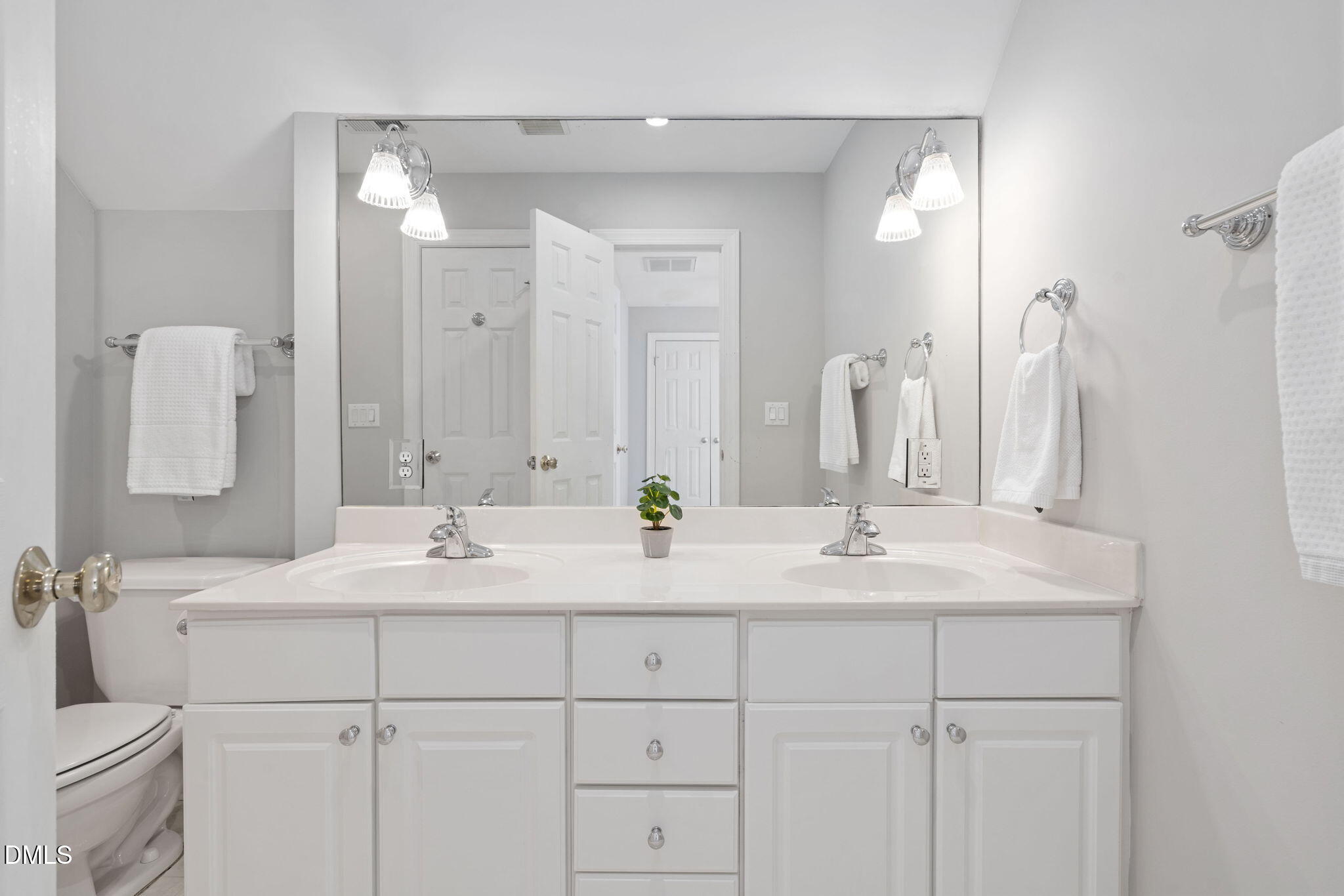 9916 Bonsal Crossing Road New Hill, NC 27562 - Photo 47 of 80 a bathroom with double sink and a mirror