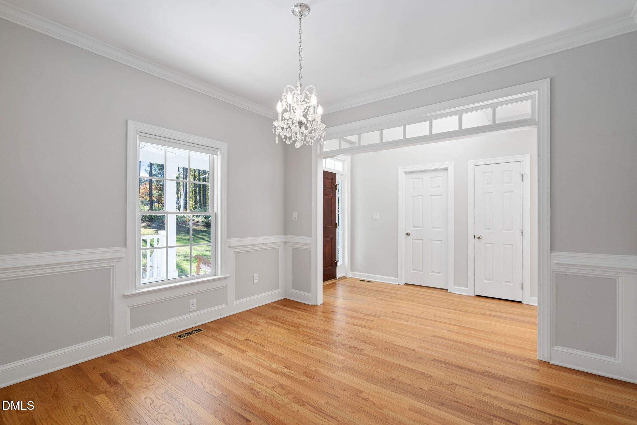 9916 Bonsal Crossing Road New Hill, NC 27562 - Photo 10 of 80 a view of an empty room with wooden floor and a window
