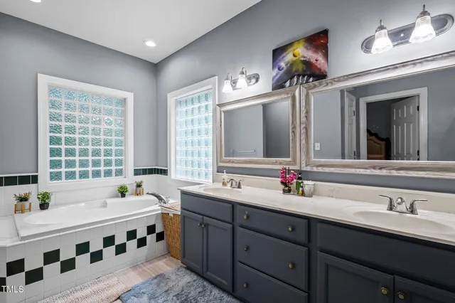 a bathroom with a double vanity sink mirror and double