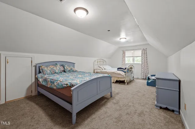 a living room with furniture and a dresser