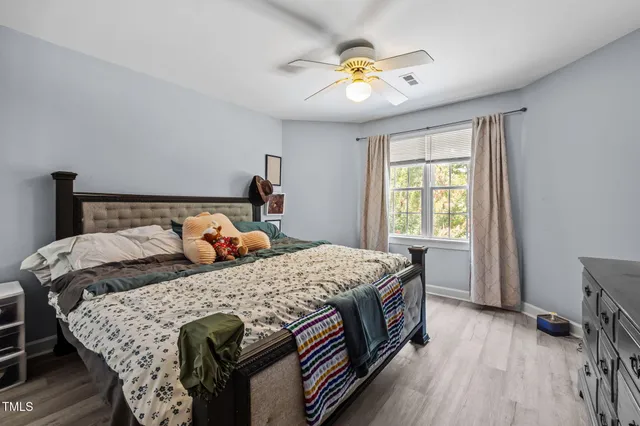 a bed sitting in a bedroom next to a window