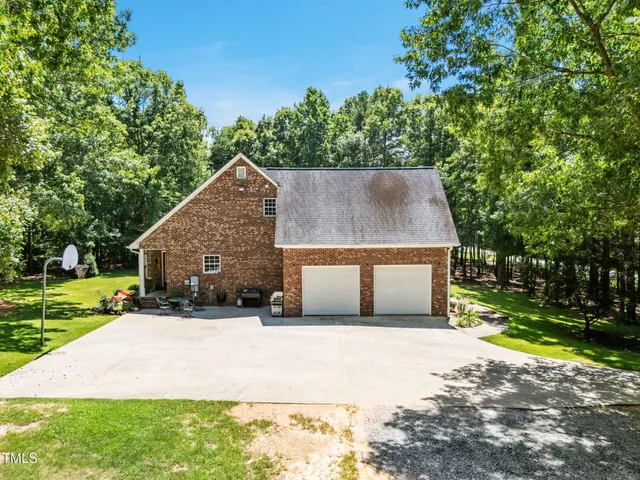front view of a house with a yard and potted plants