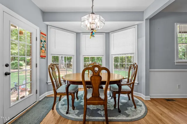 a view of a dining room with furniture wooden floor and chandelier