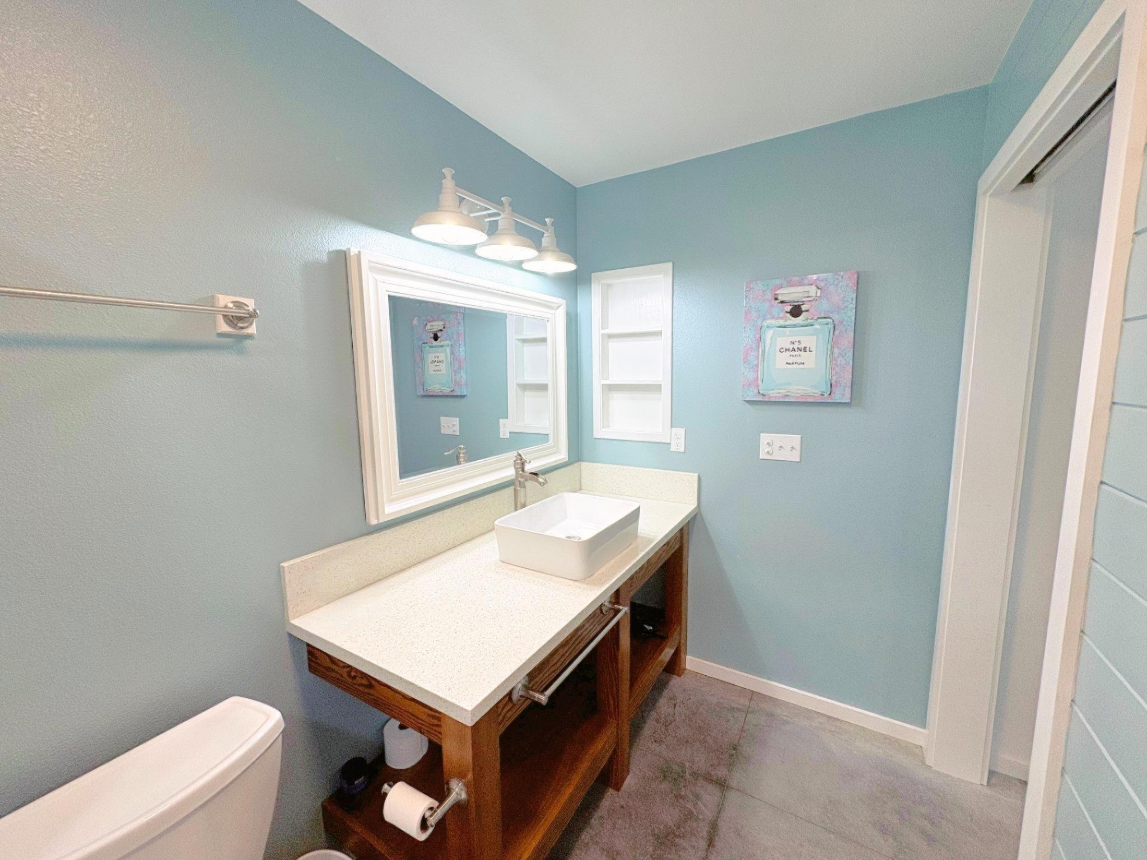 11-3083 Kaleponi Road Mountain View, HI 96771 - Photo 11 of 28 a bathroom with a sink a mirror and a toilet