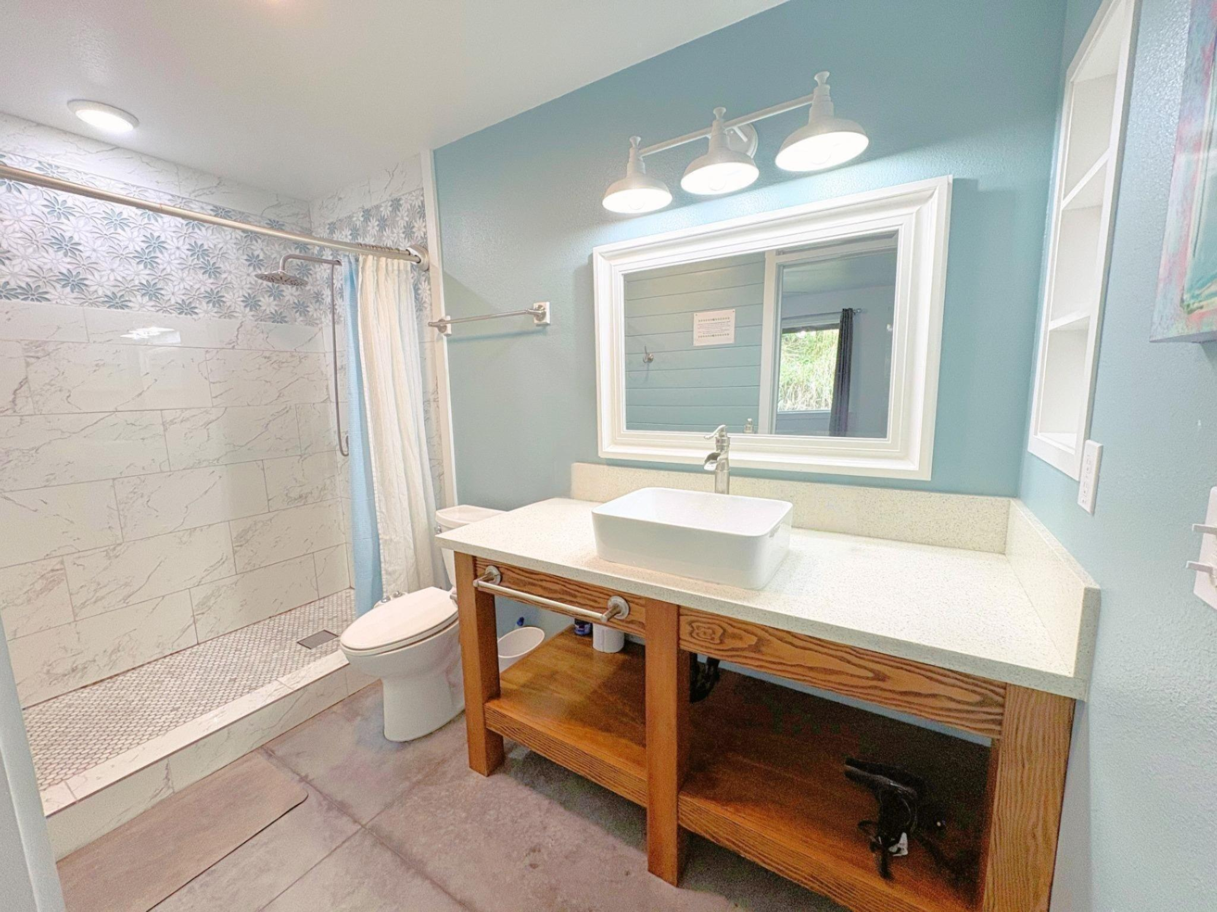 11-3083 Kaleponi Road Mountain View, HI 96771 - Photo 12 of 28 a bathroom with a sink a toilet a mirror and shower