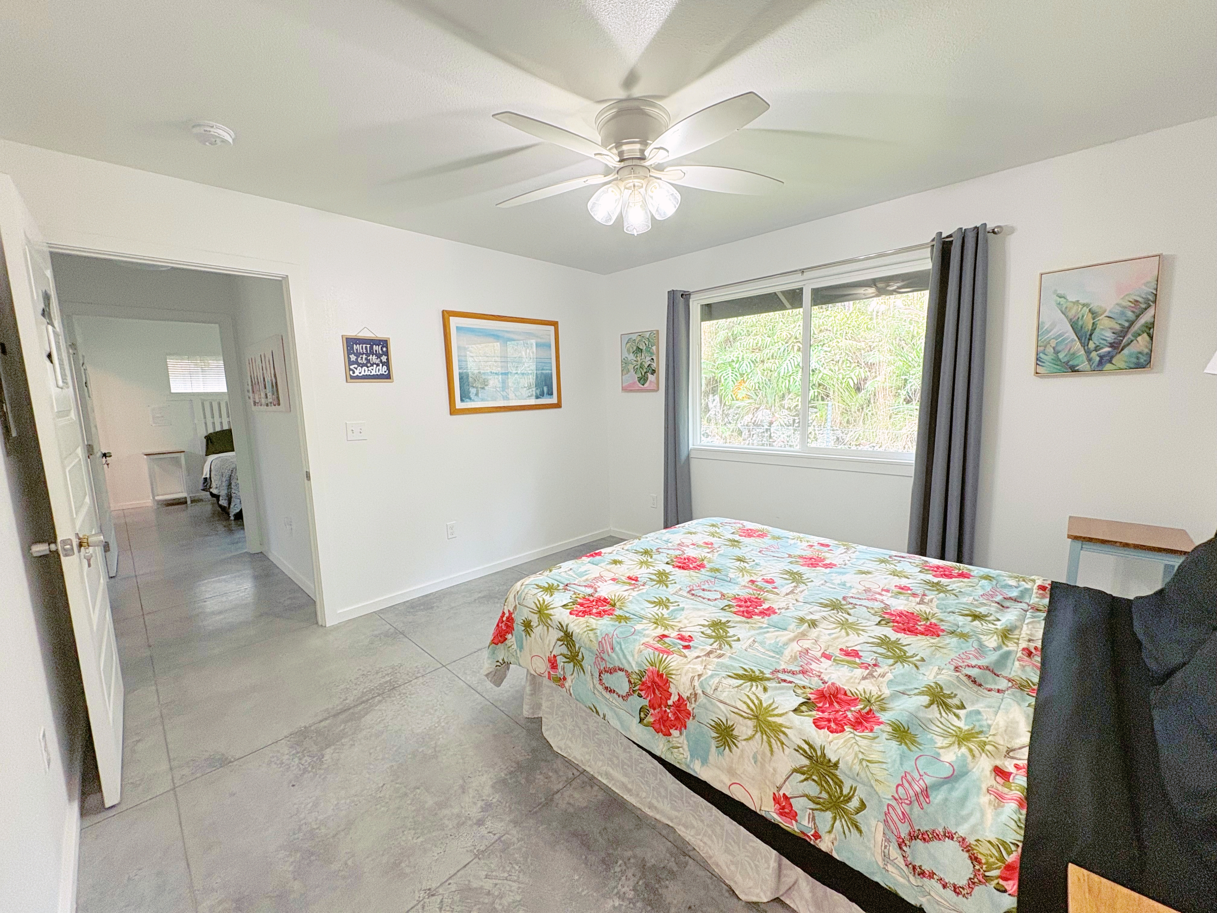 11-3083 Kaleponi Road Mountain View, HI 96771 - Photo 15 of 28 a bedroom with a bed and a chandelier