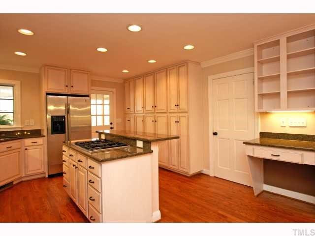 100 Byron Place Raleigh, NC 27609 - Photo 4 of 12 Plenty of cabinet space and door to the bonus room and bath in basement
