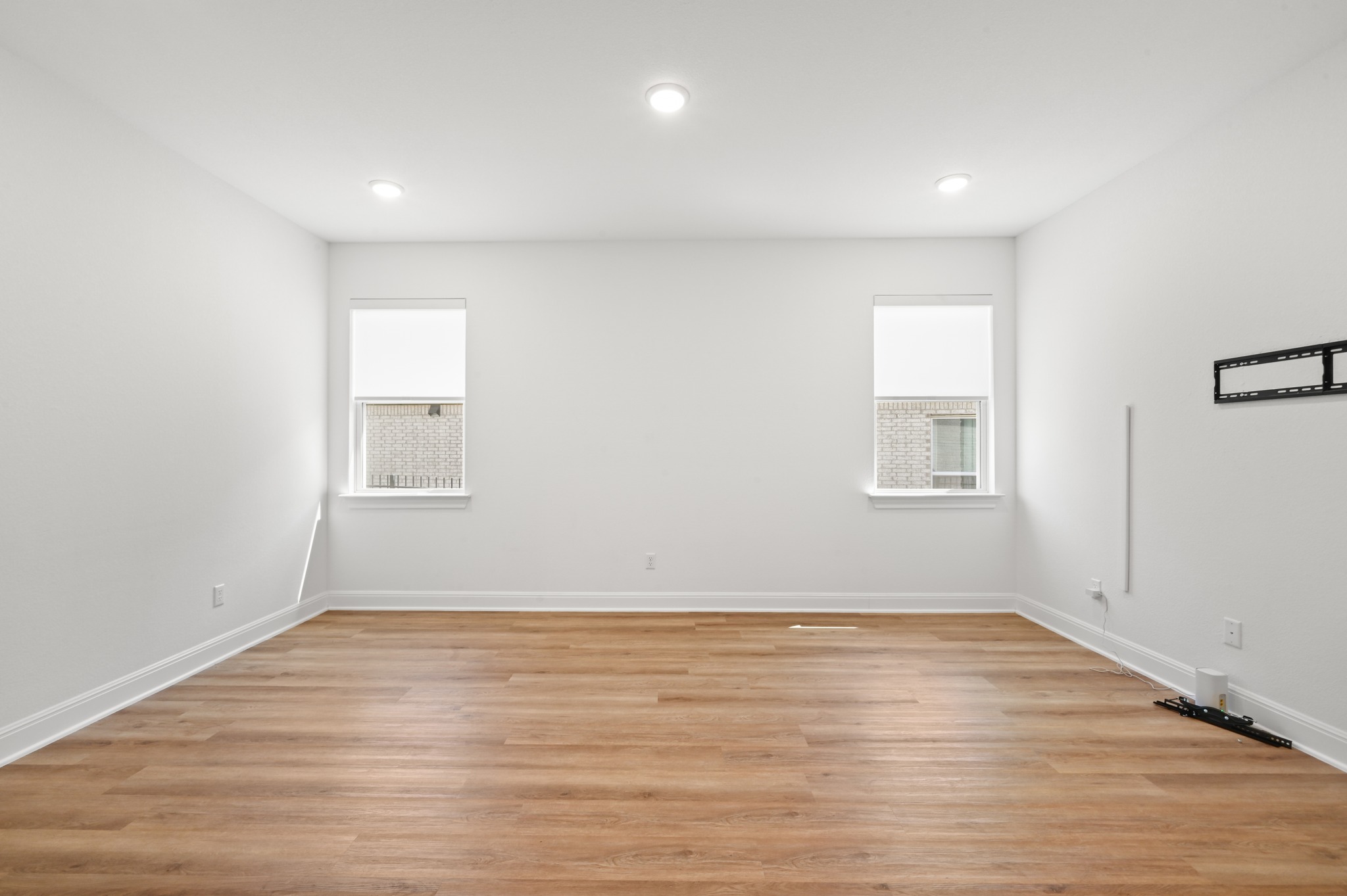 433 Running Bird Road Austin, TX 78737 - Photo 26 of 40 Recessed lighting illuminates this versatile room with durable wood flooring and abundant natural light.