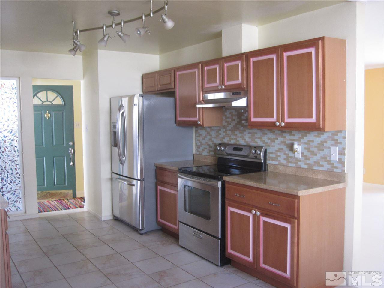 667 Beldon Way Reno, NV 89503 - Photo 3 of 13 a kitchen with stainless steel appliances granite countertop a refrigerator and a sink