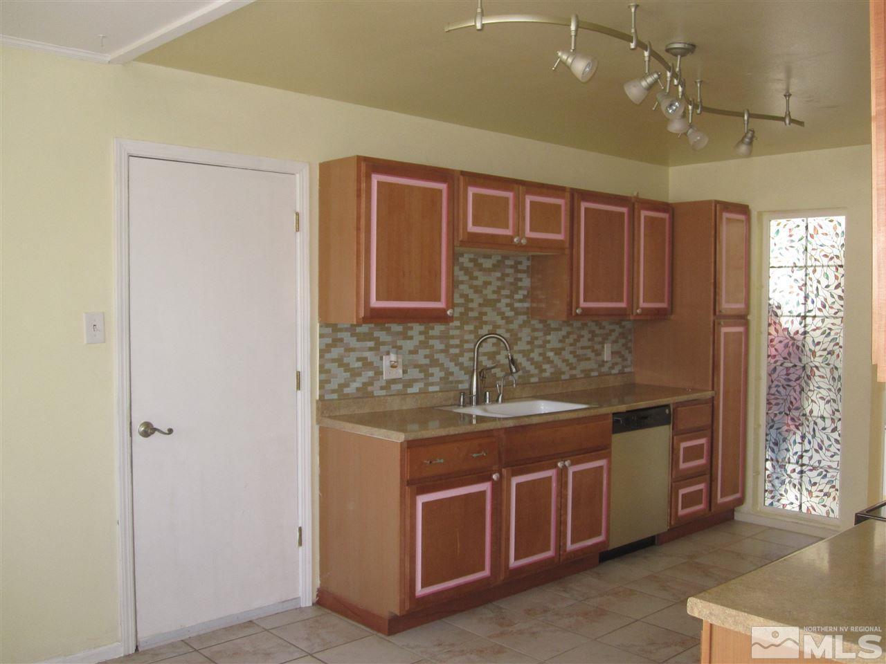 667 Beldon Way Reno, NV 89503 - Photo 4 of 13 a view of a kitchen with stainless steel appliances granite countertop a stove and a refrigerator