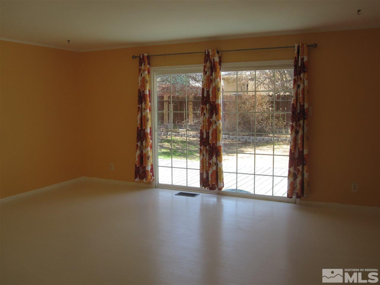 667 Beldon Way Reno, NV 89503 - Photo 5 of 13 an empty room with wooden floor and windows