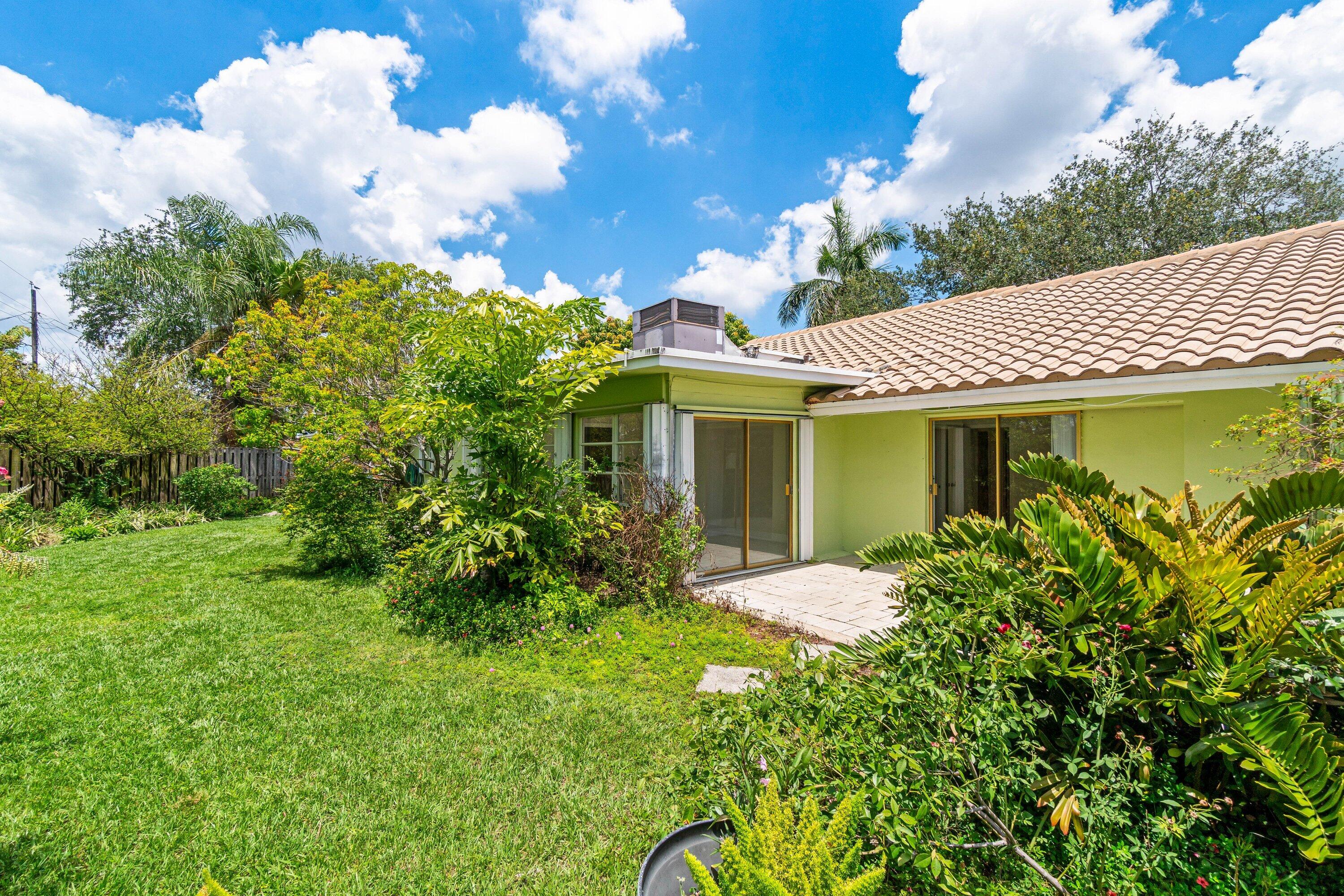 1290 Southwest 8th Street Boca Raton, FL 33486 - Photo 25 of 29 a front view of a house with garden
