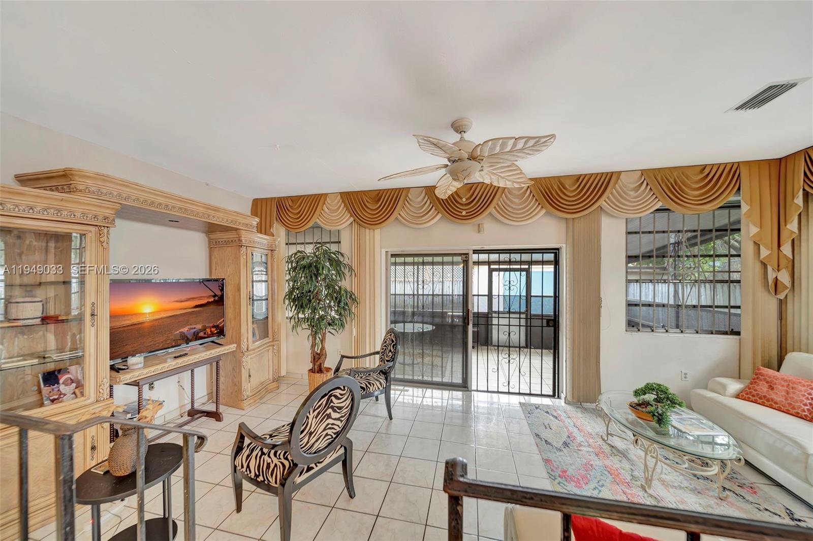 244 Northwest 43rd Street Miami, FL 33127 - Photo 11 of 29 a very nice looking living room with a large window and wooden floor