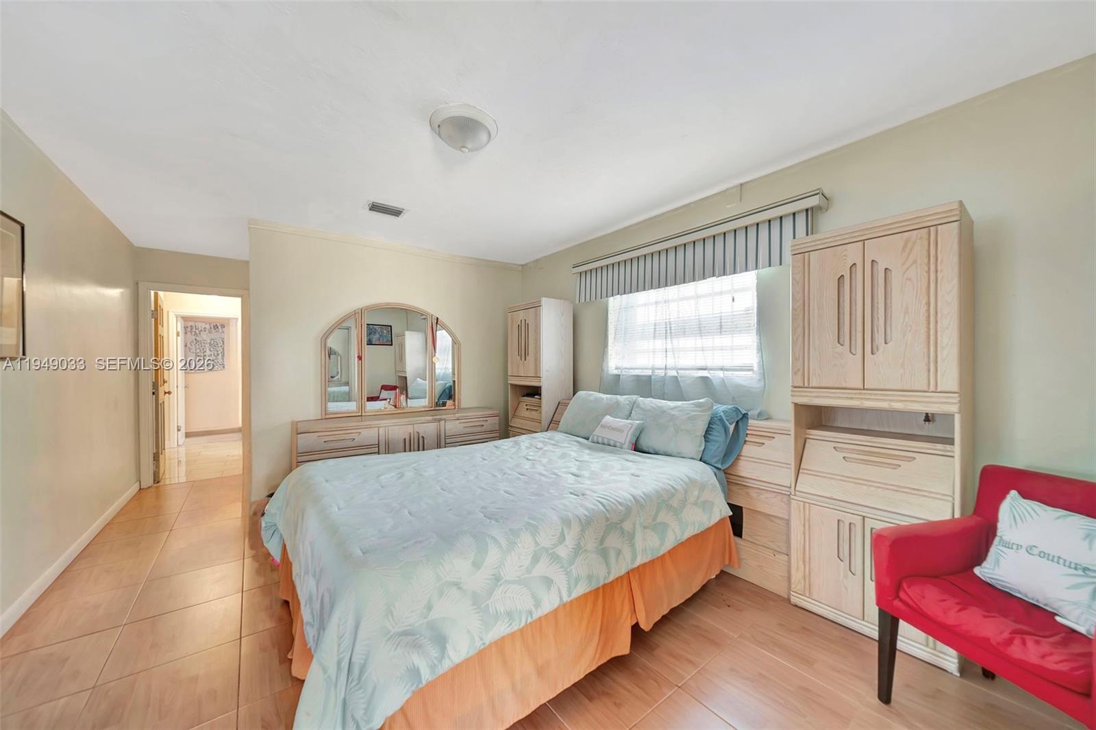 244 Northwest 43rd Street Miami, FL 33127 - Photo 14 of 29 a bedroom with a bed and wooden floor