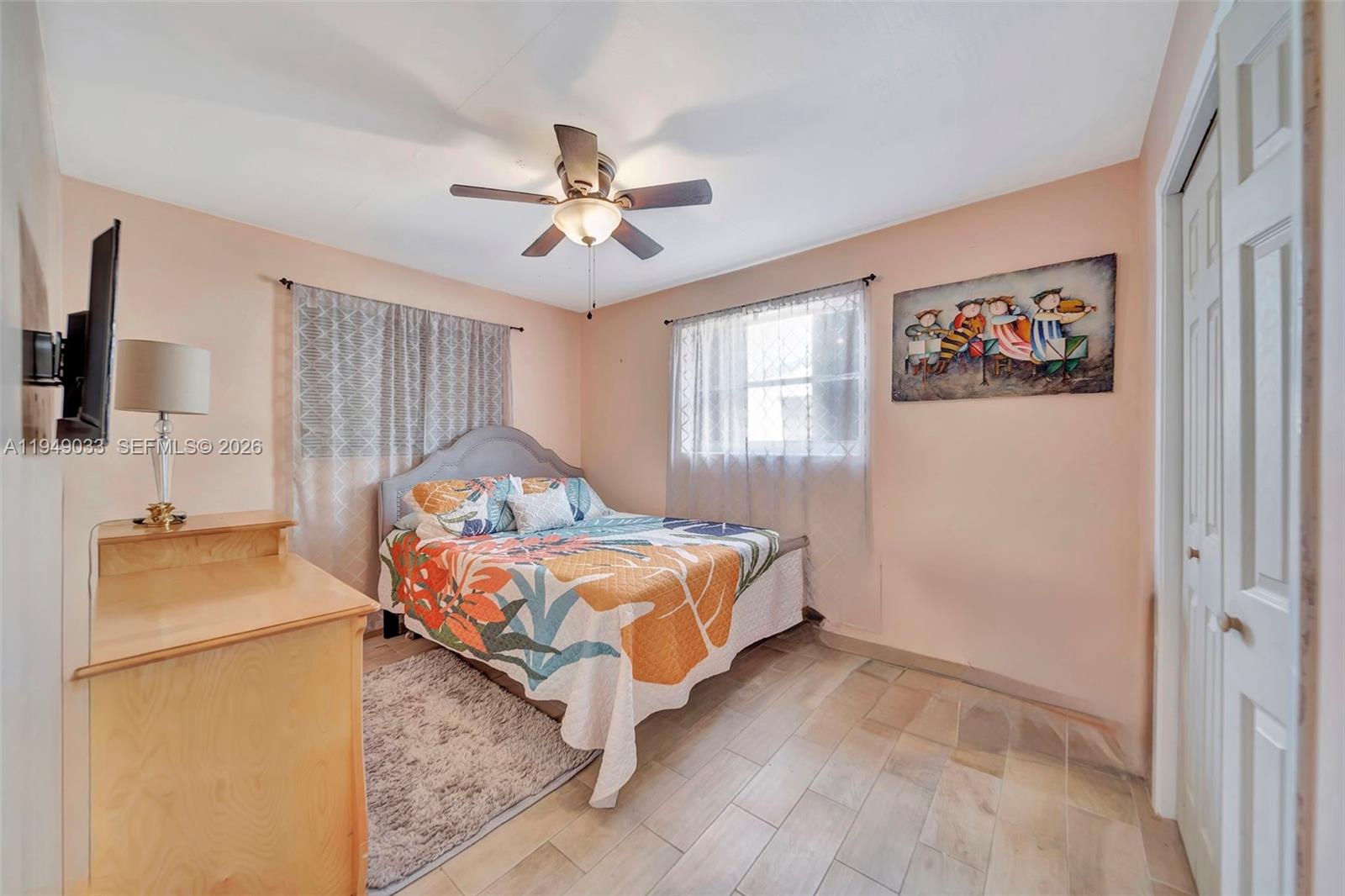 244 Northwest 43rd Street Miami, FL 33127 - Photo 18 of 29 a bedroom with a bed and a chandelier
