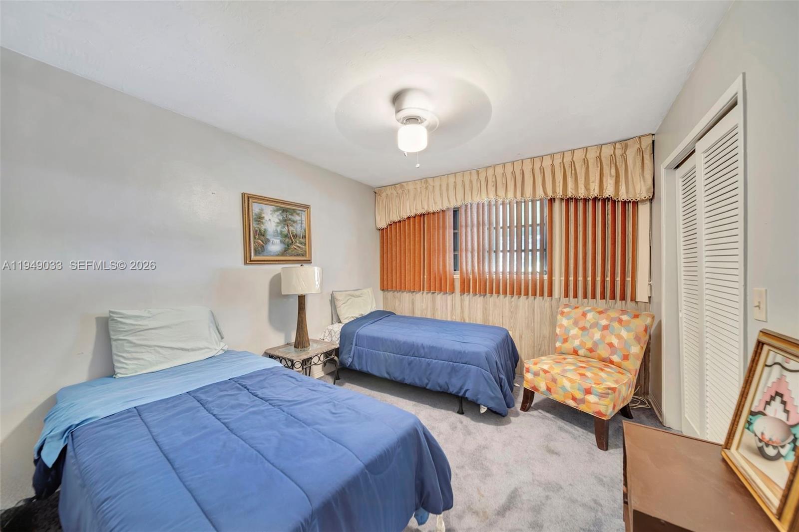 244 Northwest 43rd Street Miami, FL 33127 - Photo 19 of 29 a bedroom with two beds and a large mirror next to a window