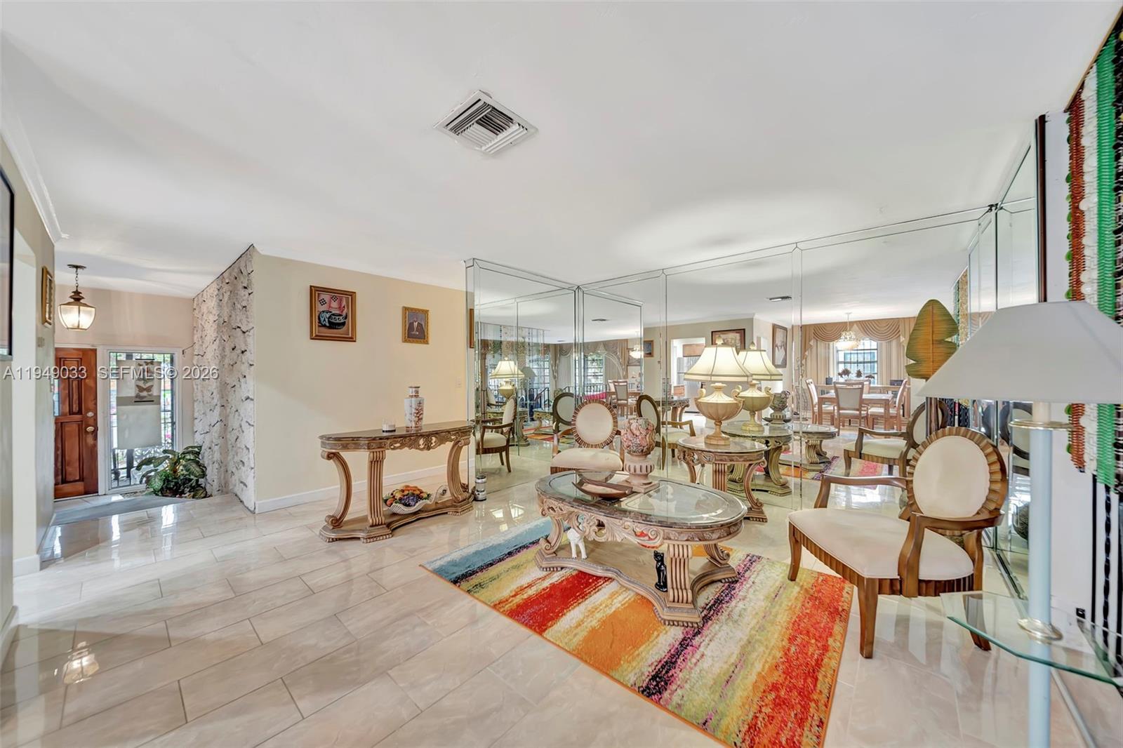 244 Northwest 43rd Street Miami, FL 33127 - Photo 4 of 29 a living room with patio furniture and a dining table with wooden floor