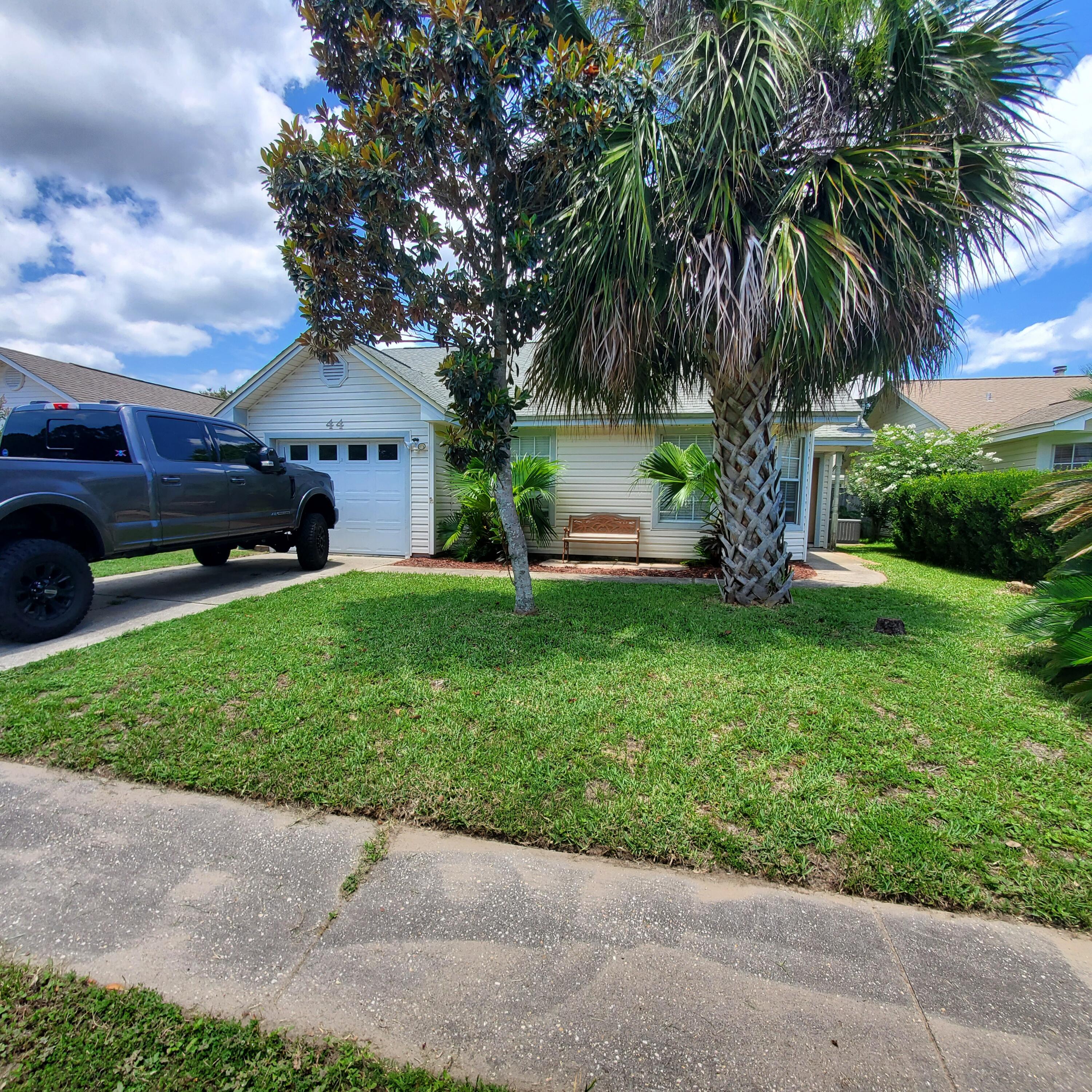44 Ruby Circle Mary Esther, FL 32569 - Photo 1 of 1 a view of a house with a yard and a car park