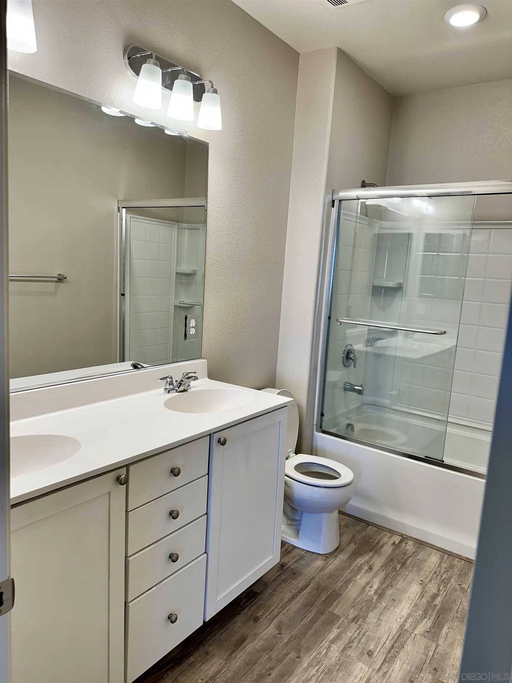 5517 Kennedy Place Rohnert Park, CA 94928 - Photo 12 of 15 a bathroom with a sink a toilet a mirror and shower