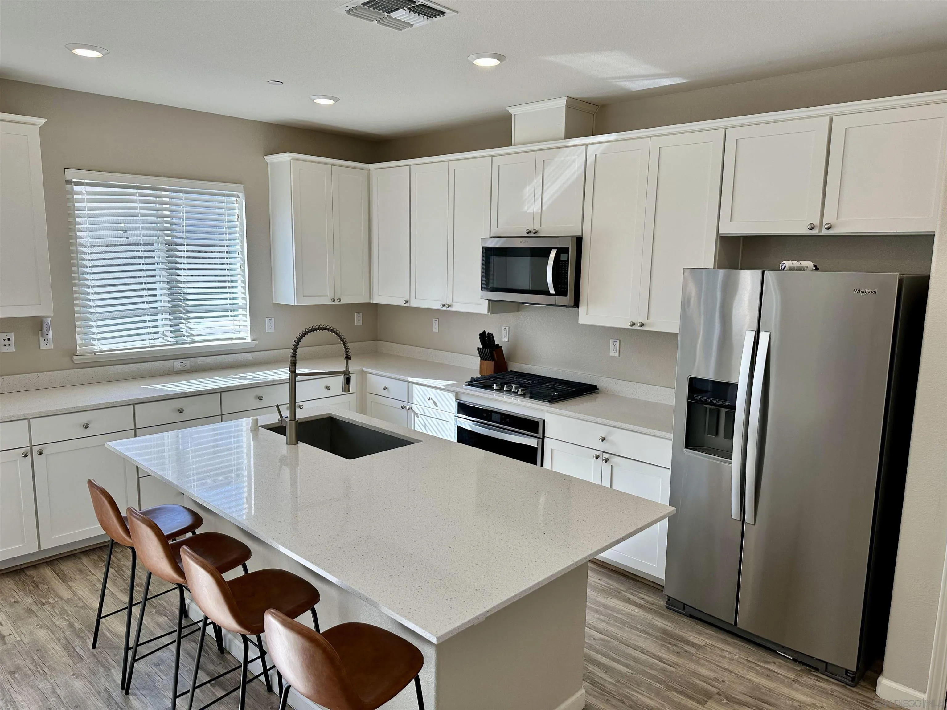 5517 Kennedy Place Rohnert Park, CA 94928 - Photo 3 of 15 a kitchen with stainless steel appliances a table chairs microwave and refrigerator