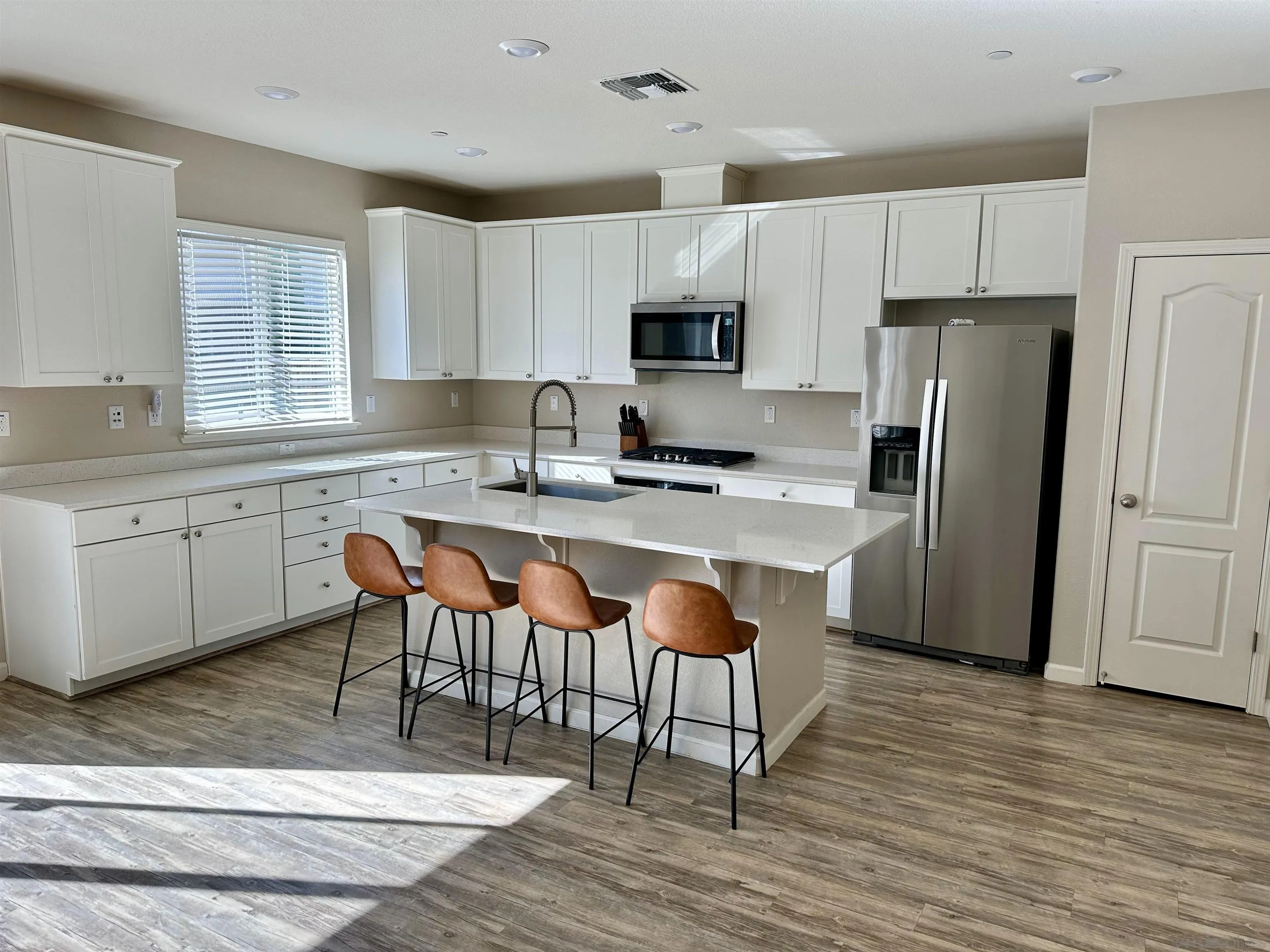 5517 Kennedy Place Rohnert Park, CA 94928 - Photo 5 of 15 a kitchen with stainless steel appliances granite countertop a table chairs sink refrigerator and cabinets