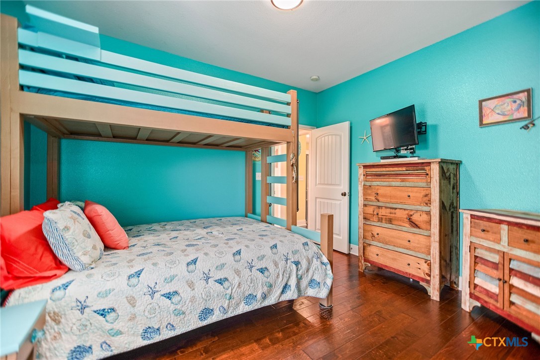 23 Macey Street Port O'Connor, TX 77982 - Photo 26 of 47 a bedroom with a bed and a dresser