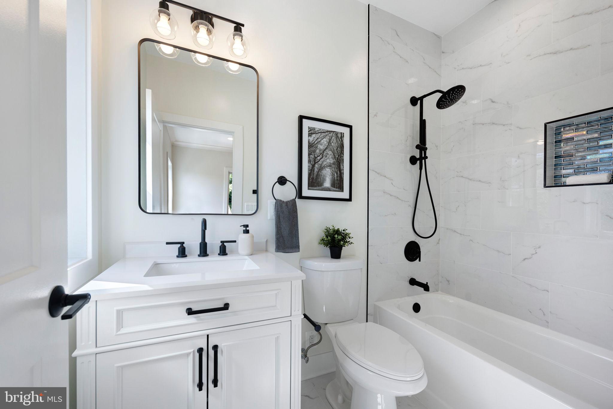 132 North Earley Street Alexandria, VA 22304 - Photo 23 of 45 a bathroom with a toilet sink shower and mirror