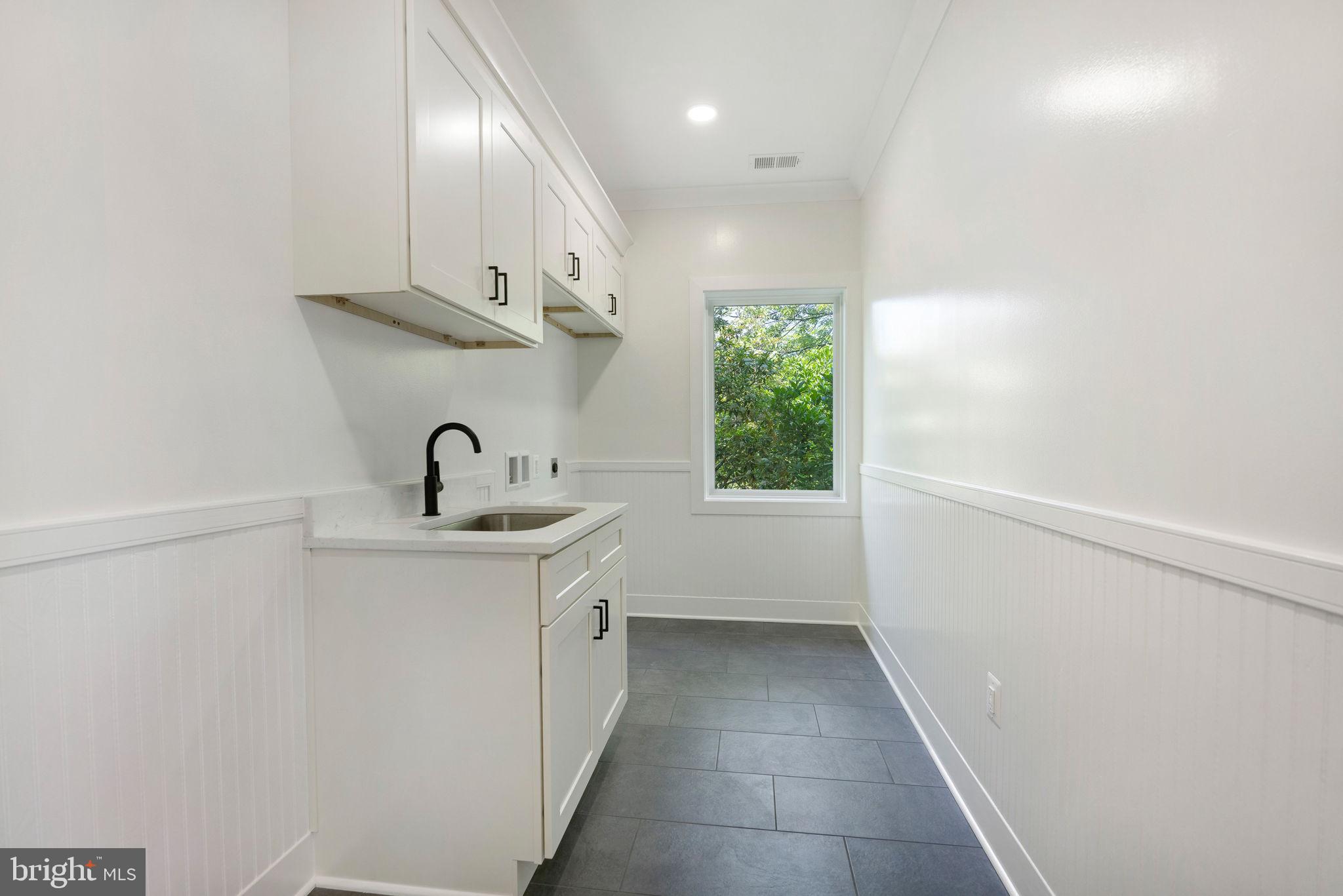 132 North Earley Street Alexandria, VA 22304 - Photo 24 of 45 a bathroom with a sink a toilet and a mirror
