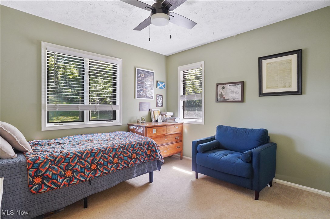 649 South Medina Line Road Akron, OH 44321 - Photo 20 of 50 Bedroom featuring light colored carpet, a textured ceiling, and ceiling fan