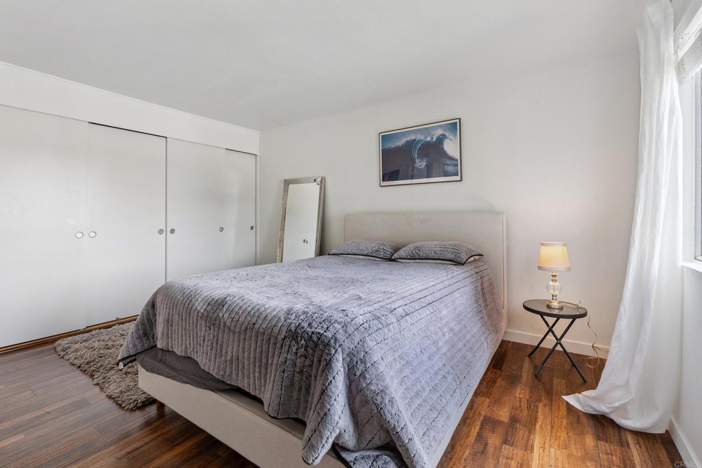 155 Rosebay Drive, Unit 31 Encinitas, CA 92024 - Photo 15 of 31 a bedroom with a bed and wooden floor