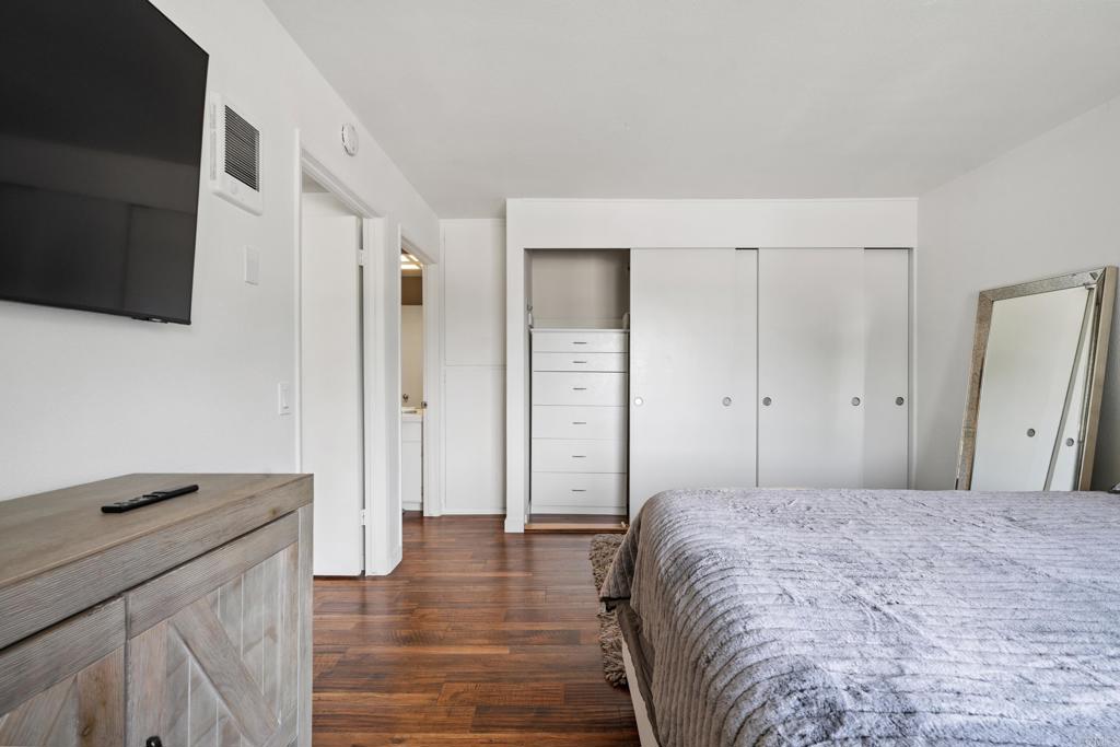 155 Rosebay Drive, Unit 31 Encinitas, CA 92024 - Photo 16 of 31 a spacious bedroom with a bed and a flat screen tv