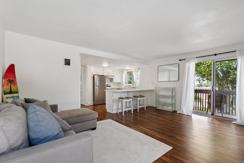 155 Rosebay Drive, Unit 31 Encinitas, CA 92024 - Photo 7 of 31 a living room with furniture wooden floor and a large window