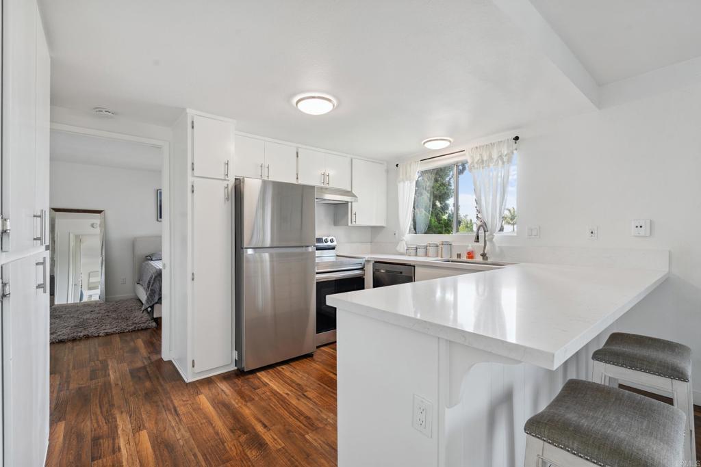 155 Rosebay Drive, Unit 31 Encinitas, CA 92024 - Photo 10 of 31 a kitchen with stainless steel appliances granite countertop a refrigerator a sink and a stove