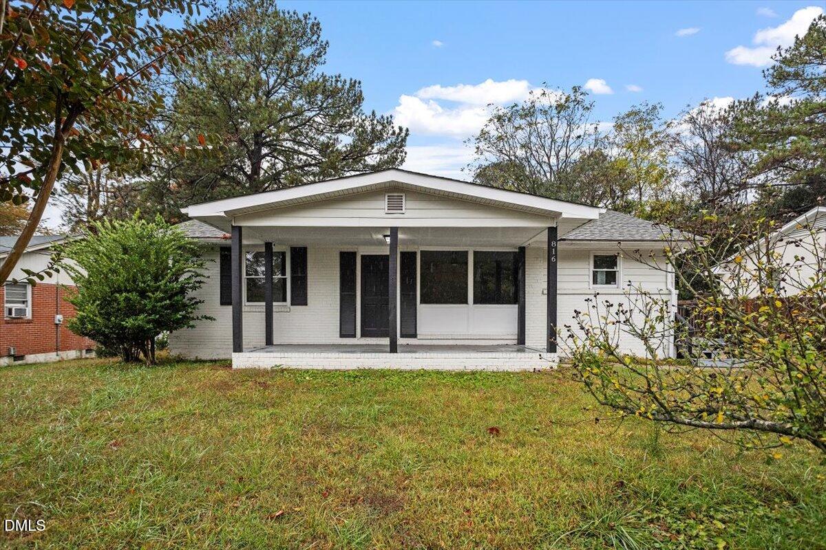 816 Peyton Street Raleigh, NC 27610 - Photo 1 of 29 a front view of a house with a garden