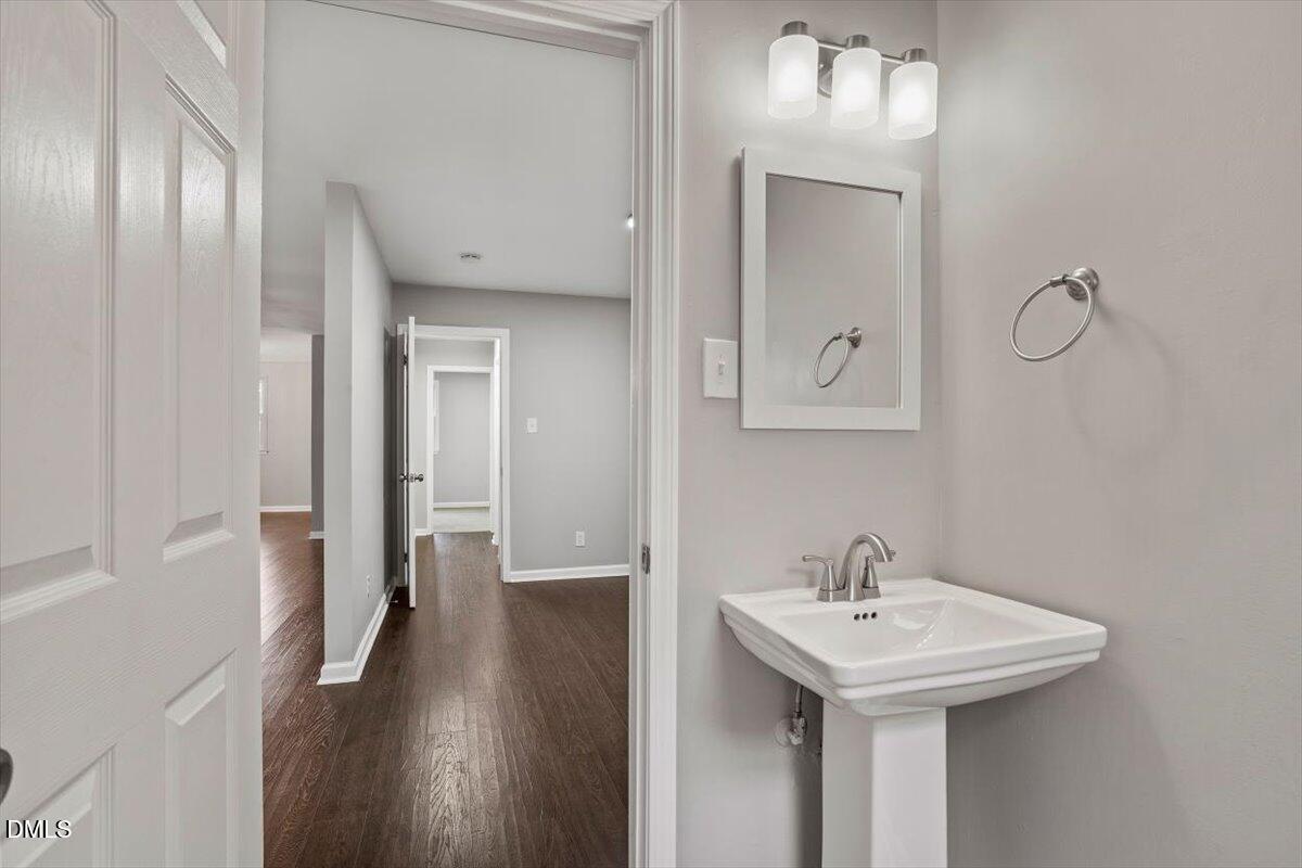 816 Peyton Street Raleigh, NC 27610 - Photo 13 of 29 a bathroom with a sink and a mirror