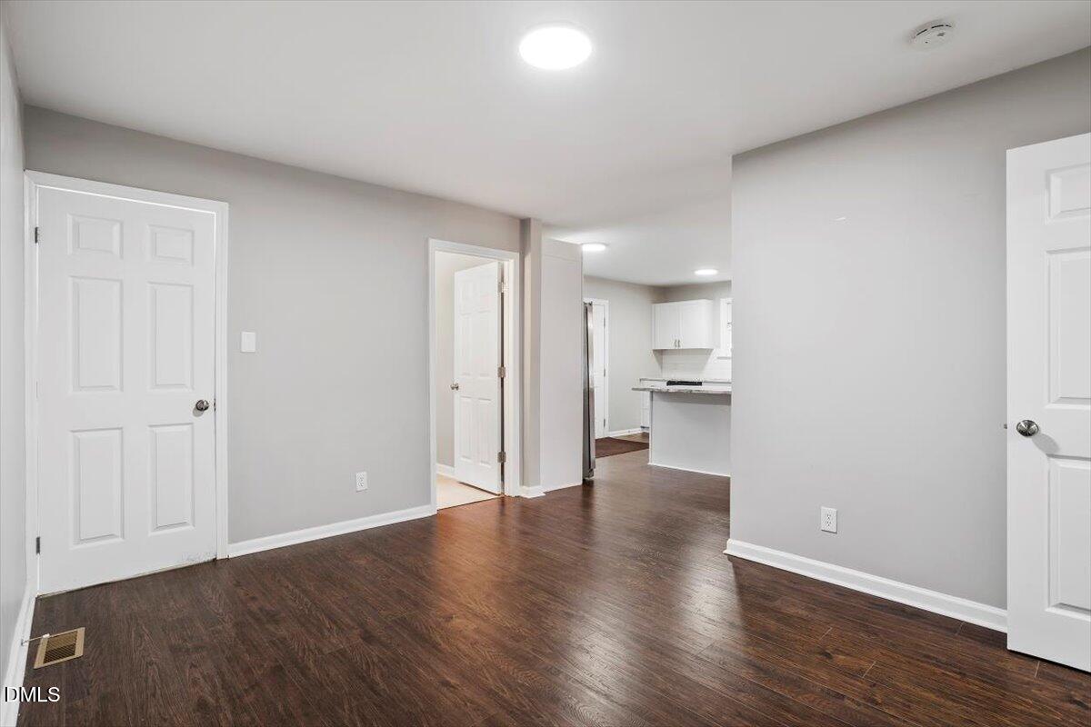 816 Peyton Street Raleigh, NC 27610 - Photo 15 of 29 a view of a kitchen with wooden floor and a window