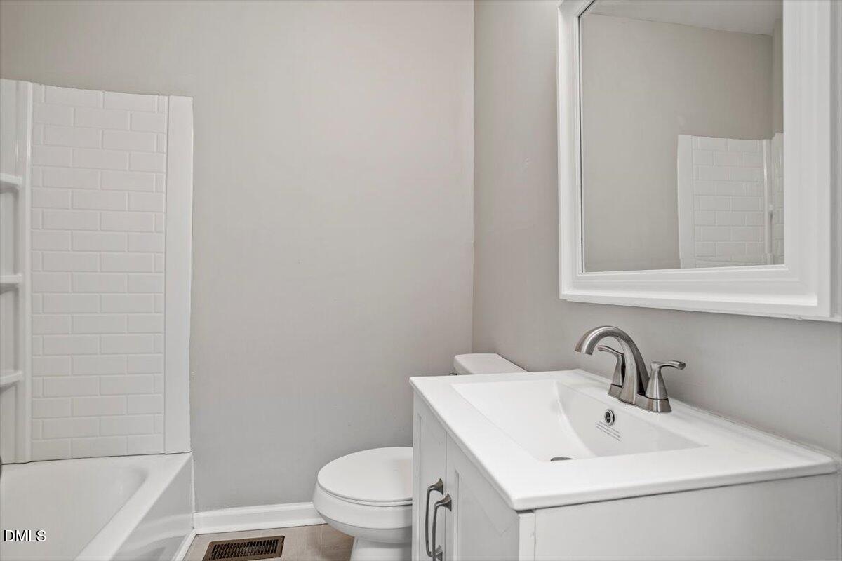 816 Peyton Street Raleigh, NC 27610 - Photo 16 of 29 a bathroom with a sink and a toilet