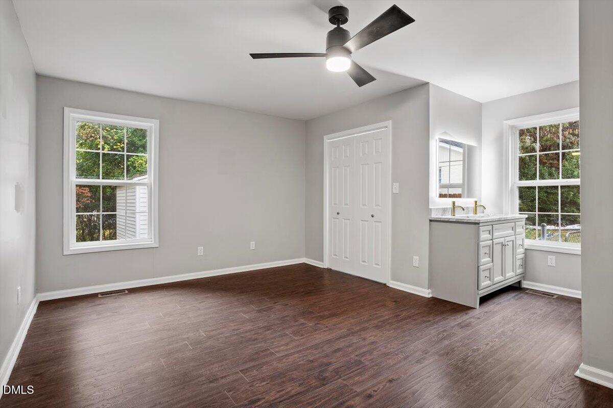 816 Peyton Street Raleigh, NC 27610 - Photo 19 of 29 a view of an empty room with a window and wooden floor