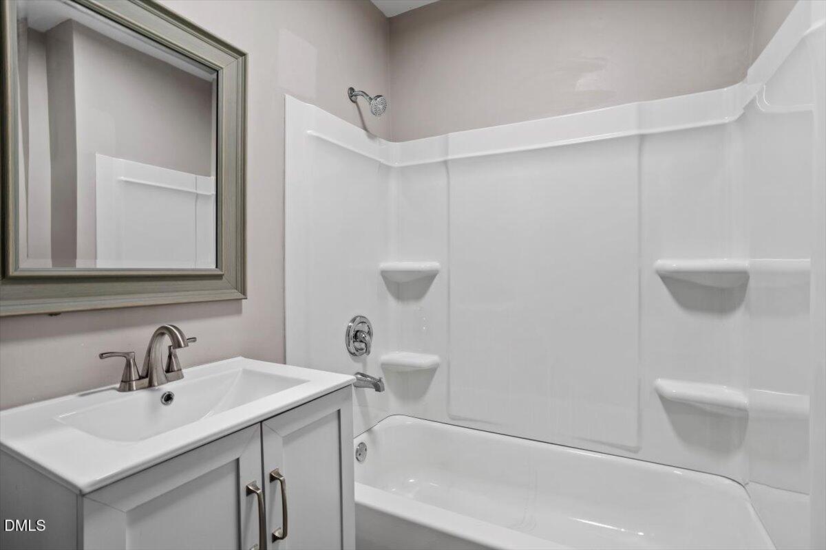 816 Peyton Street Raleigh, NC 27610 - Photo 24 of 29 a bathroom with a sink a toilet and shower