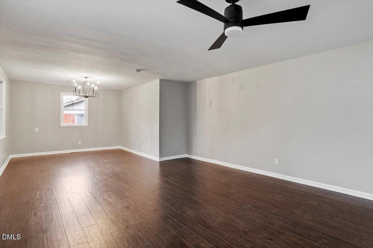 816 Peyton Street Raleigh, NC 27610 - Photo 7 of 29 wooden floor in an empty room with a window