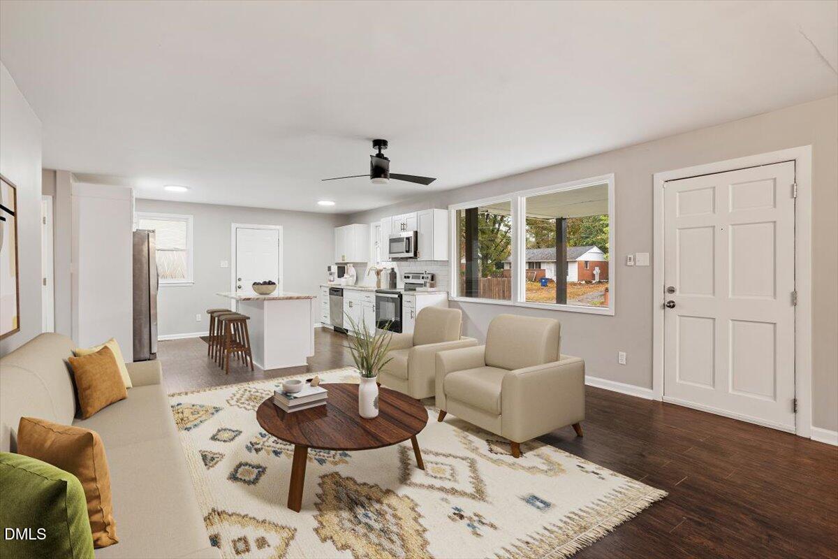 816 Peyton Street Raleigh, NC 27610 - Photo 10 of 29 a living room with furniture and a wooden floor