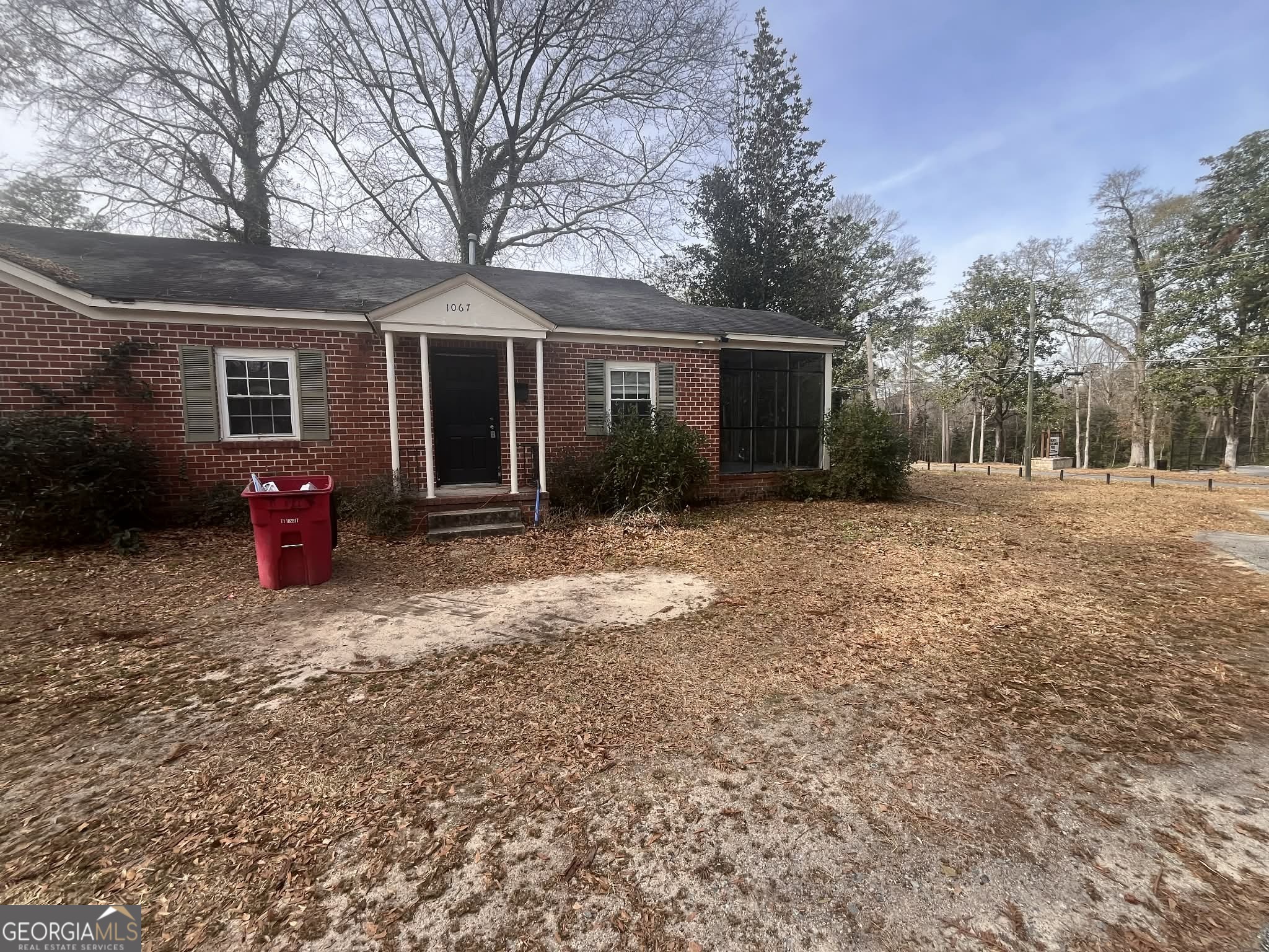 a backyard of a house with barbeque oven and outdoor seating