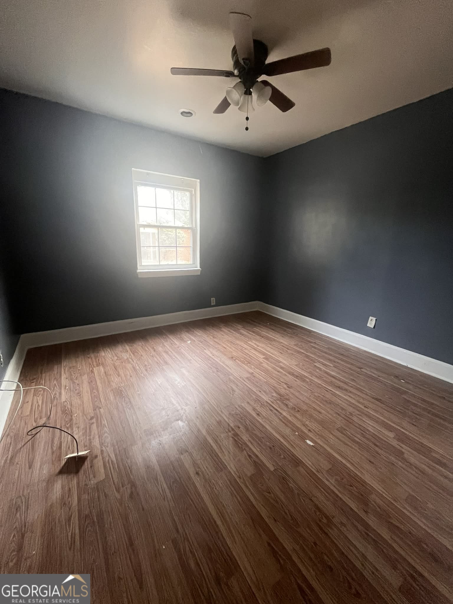 1067 Boulevard Macon, GA 31211 - Photo 3 of 7 wooden floor in an empty room with a window