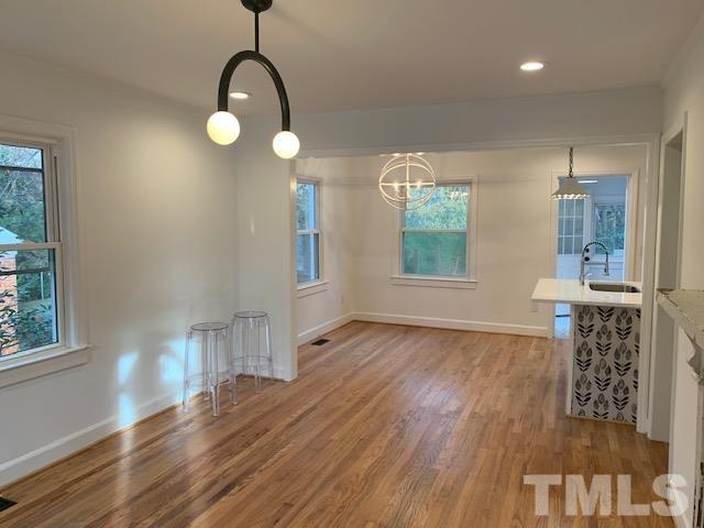 1212 Watauga Street Raleigh, NC 27604 - Photo 5 of 33 a view of a room with wooden floor and windows