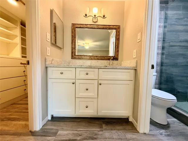 a bathroom with a sink a toilet and a mirror