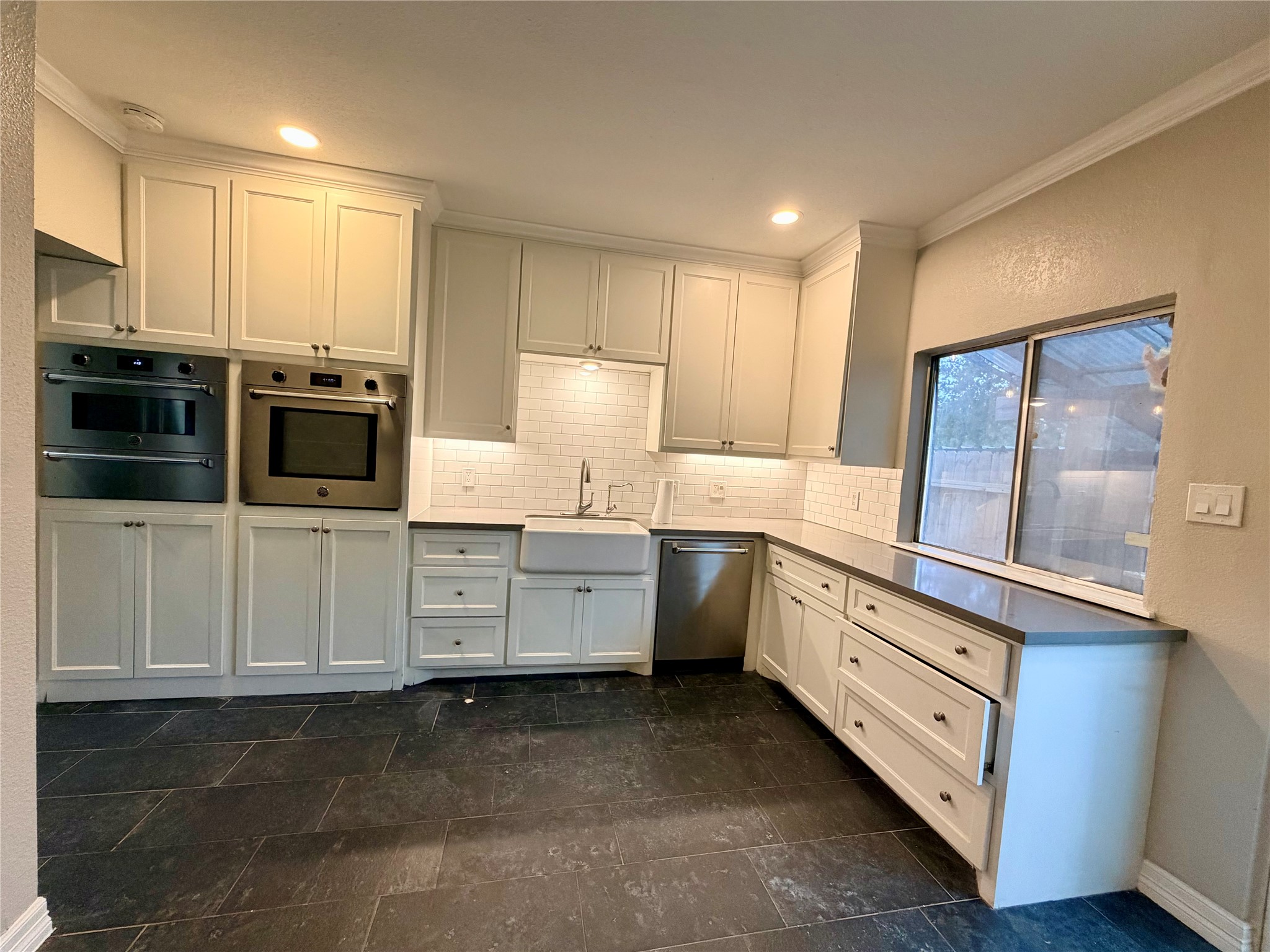 811 Threadneedle Street, Unit 267 Houston, TX 77079 - Photo 6 of 21 a kitchen with granite countertop white cabinets and stainless steel appliances
