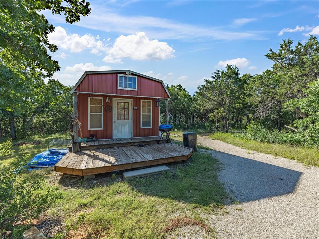 3275 Finis Road Graham, TX 76450 - Photo 26 of 36 a view of a house with backyard porch and sitting area