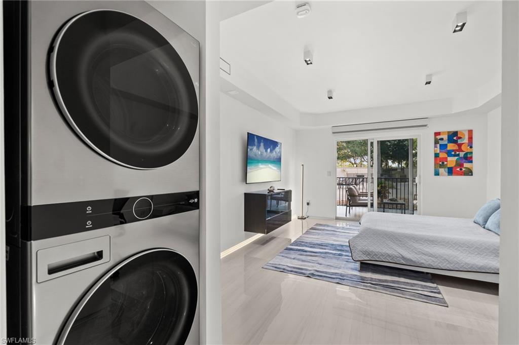 1100 Pine Ridge Road, Unit B103 Naples, FL 34108 - Photo 22 of 38 a bedroom with a bed and a large window