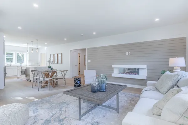 a living room with furniture and a dining table