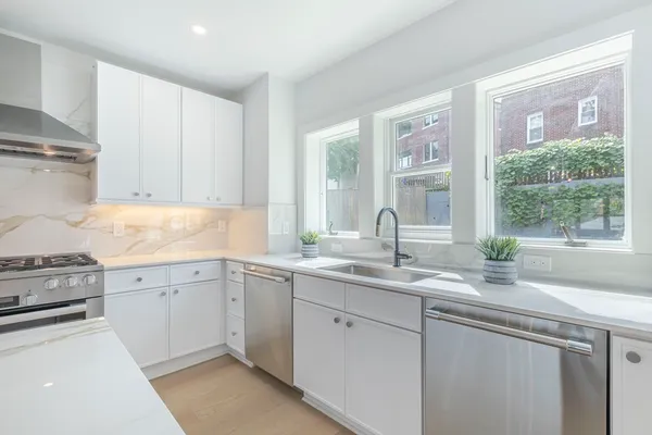 a kitchen with a sink stove and cabinets